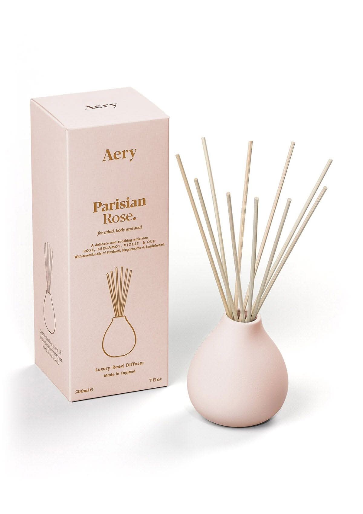Pale pink Parisian Rose diffuser displayed next to product packaging by Aery on white bacground