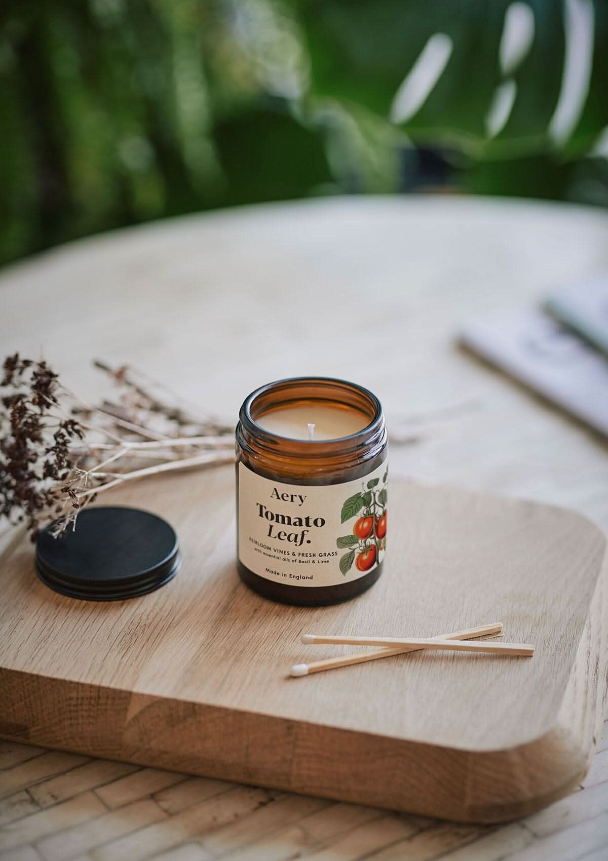 Tomato Leaf jar candle by Aery displayed on wooden tray with match sticks
