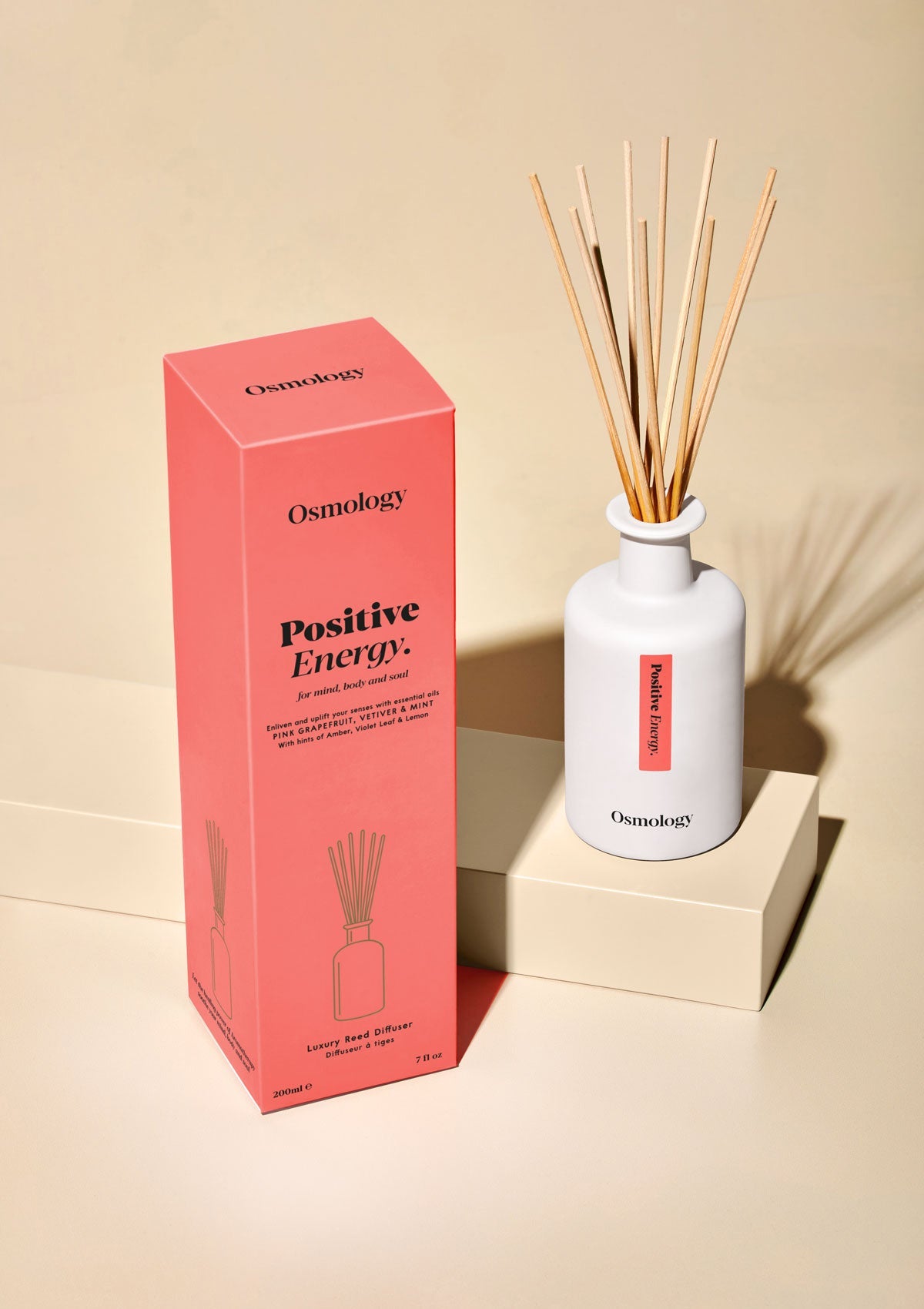 Osmology Positive Energy diffuser with packaging on a beige background