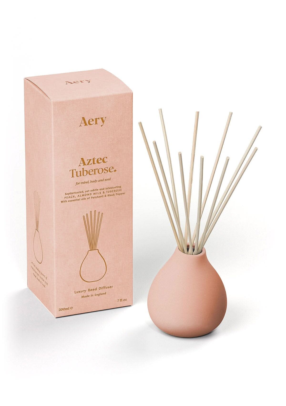Peach Aztec Tuberose diffuser displayed next to product packaging by Aery on white bacground
